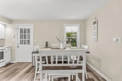 a kitchen and dining room with a white table and chairs at North Haven Charm, 3BD Yale Retreat in North Haven