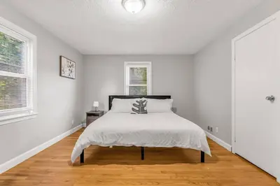a white bedroom with a bed and a window at North Haven Charm, 3BD Yale Retreat in North Haven