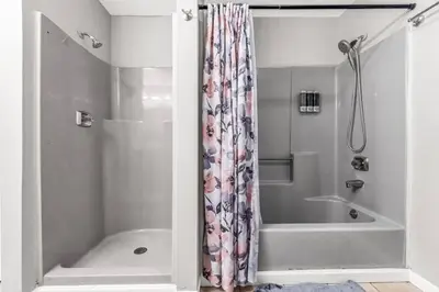 a bathroom with a shower curtain and a tub at North Haven Charm, 3BD Yale Retreat in North Haven