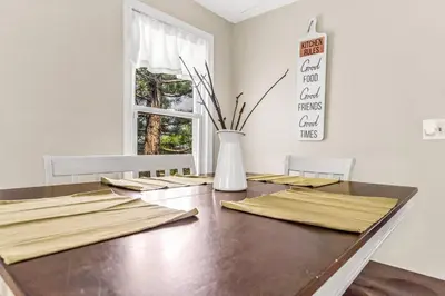 a dining room table with a vase on it at North Haven Charm, 3BD Yale Retreat in North Haven