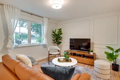 a living room with a couch and a tv at Glen Cove Vacation Rental Less Than 1 Mi to Downtown! in Glen Cove