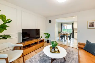 a living room with a couch and a tv at Glen Cove Vacation Rental Less Than 1 Mi to Downtown! in Glen Cove
