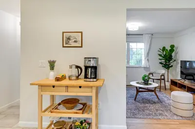 a living room with a table with a coffee maker at Glen Cove Vacation Rental Less Than 1 Mi to Downtown! in Glen Cove