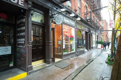 an empty city street with a bunch of shops at West Village 1br w high ceilings skylight wd NYC-1172 in New York