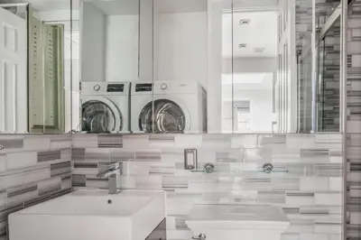 a bathroom with a sink and two washing machines at West Village 1br w high ceilings skylight wd NYC-1172 in New York