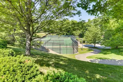 a tree in a park with a tennis court at All-Season Vernon Township Lake House Retreat! in Vernon Township