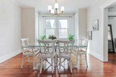 a dining room with a glass table and chairs at Grace's Place - 3 Bedroom Townhouse in Greenwich in Greenwich
