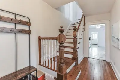 a staircase in a home with white walls and wooden floors at Grace's Place - 3 Bedroom Townhouse in Greenwich in Greenwich
