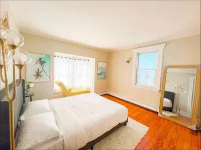 a bedroom with a large white bed and a mirror at Grace's Place - 3 Bedroom Townhouse in Greenwich in Greenwich