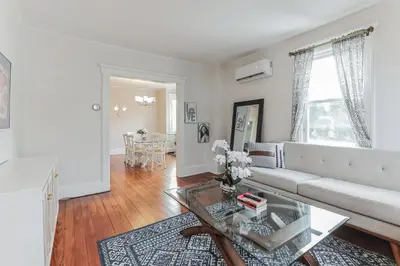 a living room with a white couch and a glass table at Grace's Place - 3 Bedroom Townhouse in Greenwich in Greenwich