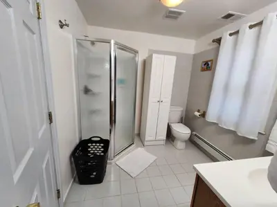 a bathroom with a shower and a toilet at RentalsOP NJ01 Full house minutes from NYC, near to metlife, American Dream in Hackensack