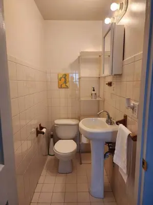 a small bathroom with a toilet and a sink at RentalsOP NJ01 Full house minutes from NYC, near to metlife, American Dream in Hackensack