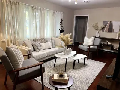 a living room with a couch and tables and chairs at Hudson Haven in Hudson