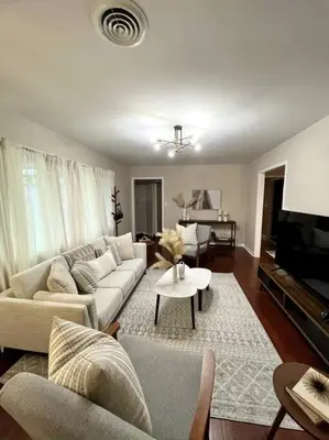 a living room with a couch and a tv at Hudson Haven in Hudson