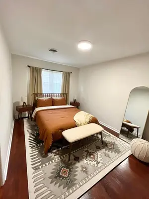 a bedroom with a large bed and a window at Hudson Haven in Hudson