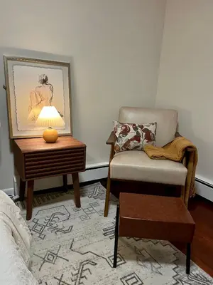 a living room with a chair and a table at Hudson Haven in Hudson