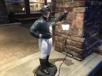 a statue of a baseball player standing on a board at Landmark Motor Inn in Glens Falls