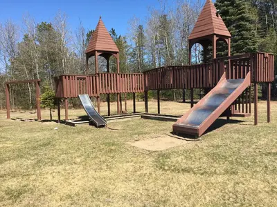 a playground with two slides and two gazebos at Landmark Motor Inn in Glens Falls