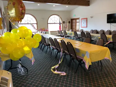 a conference room with a long table with balloons at Landmark Motor Inn in Glens Falls
