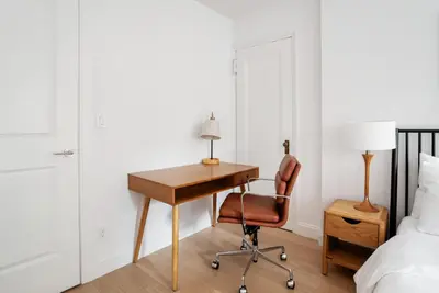 a bedroom with a desk and a bed at Midtown East 1br w doorman nr Grand Central NYC-1170 in New York