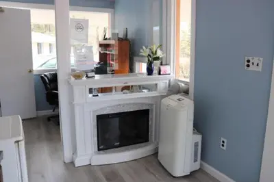 a living room with a fireplace in a room at Hitching Post Motel in Cornwall