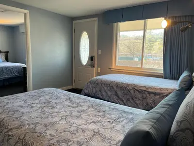 a hotel room with two beds and a window at Hitching Post Motel in Cornwall
