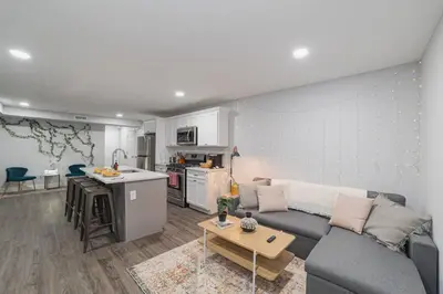 a living room with a couch and a kitchen at Suite Dreams 2BR Parking Yale New Haven Lawn Club in New Haven
