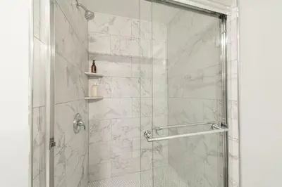 a bathroom with a shower with a glass door at Suite Dreams 2BR Parking Yale New Haven Lawn Club in New Haven