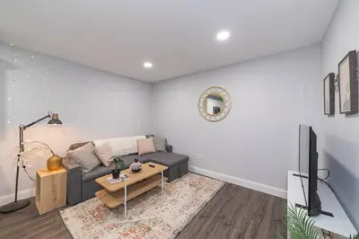 a living room with a couch and a tv at Suite Dreams 2BR Parking Yale New Haven Lawn Club in New Haven