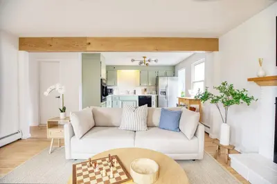 a living room with a couch and chessboard at Fairfield Cottage -Top Rated Gem, Fire Pit, Near Beach, 90 Min to NYC in Fairfield