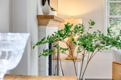a dining room table with a plant and a lamp at Fairfield Cottage -Top Rated Gem, Fire Pit, Near Beach, 90 Min to NYC in Fairfield