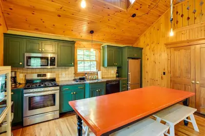 a kitchen with green cabinets and a wooden ceiling at Secluded Elka Park Cabin Hot Tub and Fire Pit! in Elka Park