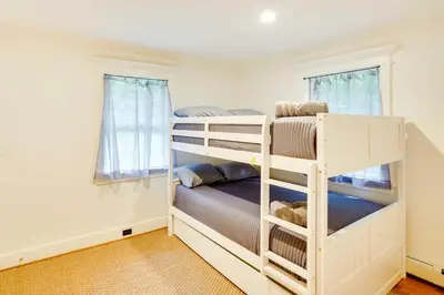 a bedroom with two bunk beds and a window at Secluded Elka Park Cabin Hot Tub and Fire Pit! in Elka Park