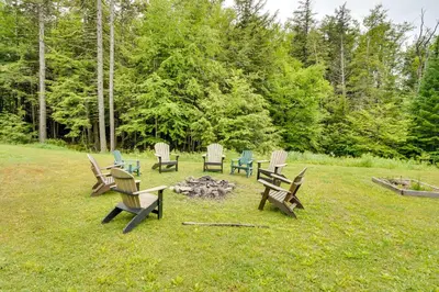 a group of benches sitting around a fire in a field at Secluded Elka Park Cabin Hot Tub and Fire Pit! in Elka Park