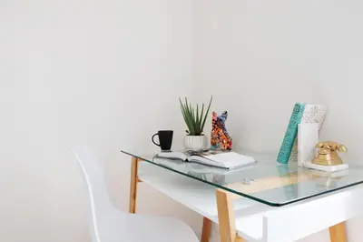 a glass table with a white chair next to it at 78-4A 2BR Duplex with a Balcony Prime UES in New York