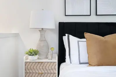 a bedroom with a bed with a lamp on a night stand at 78-4A 2BR Duplex with a Balcony Prime UES in New York