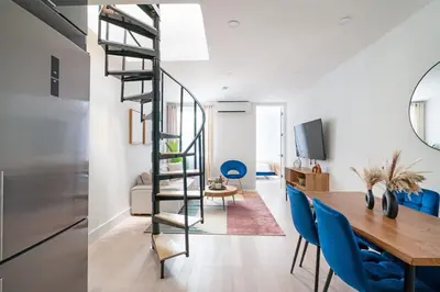 a kitchen and dining room with a spiral staircase in a house at 78-4A 2BR Duplex with a Balcony Prime UES in New York
