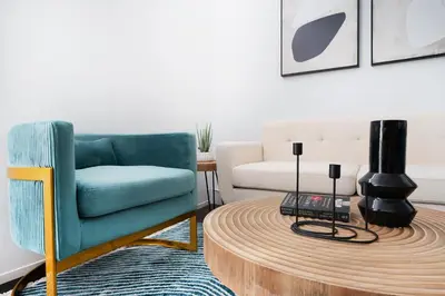 a living room with a blue chair and a coffee table at 444-2C Newly renovated 1BR in Hell's Kitchen in New York