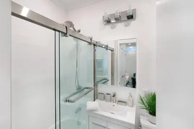 a bathroom with a glass shower and a sink at 444-4F Newly renovated 1BR in Midtown West in New York