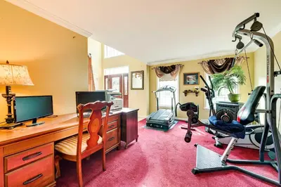 a room with a desk with a computer and exercise equipment at Woodsy Ballston Spa Home 4 Mi to State Park! in Ballston Spa