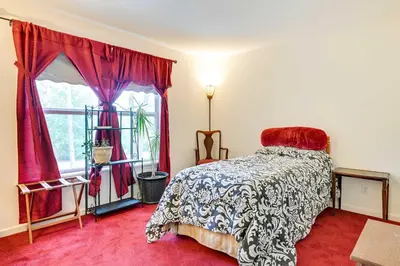 a bedroom with a bed and a window at Woodsy Ballston Spa Home 4 Mi to State Park! in Ballston Spa