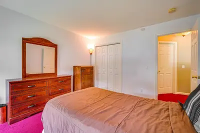 a bedroom with a bed and a dresser and a mirror at Woodsy Ballston Spa Home 4 Mi to State Park! in Ballston Spa