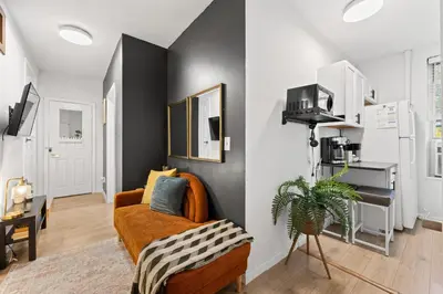 a living room with a couch and a table at Convenient 2BR - Walking distance to Times Square in New York