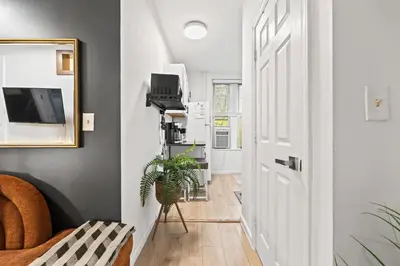 a hallway with a white door and a plant at Convenient 2BR - Walking distance to Times Square in New York