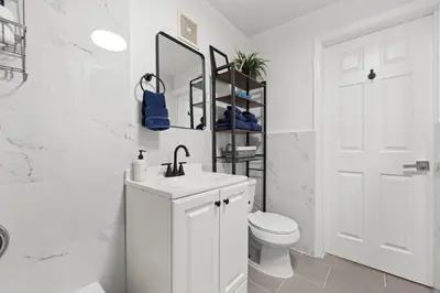 a white bathroom with a sink and a toilet at Convenient 2BR - Walking distance to Times Square in New York