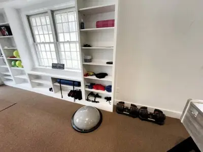 a room with a window and shelves with shoes at Cottage Retreat - Historic Cottage Home w Home Gym in Cornwall