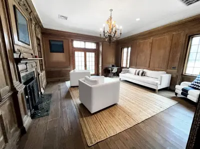 a living room with white furniture and a fireplace at Cottage Retreat - Historic Cottage Home w Home Gym in Cornwall