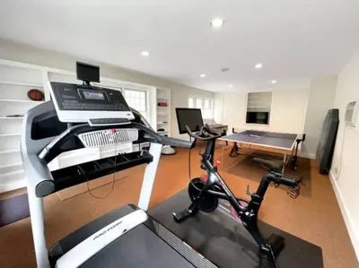a room with a gym with a treadmill and a desk at Cottage Retreat - Historic Cottage Home w Home Gym in Cornwall