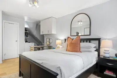 a bedroom with a large bed with a mirror on it at Studio Haven in Times Square & Nearby Restaurants in New York