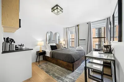 a bedroom with a bed and some windows at Midtown Studio - Walking Distance to Times Square in New York